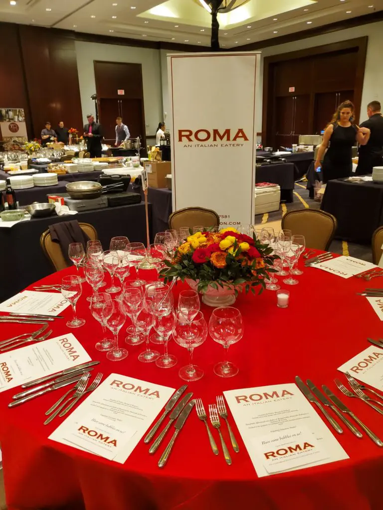 Chef Angelo Cuppone and his team and Roma dress their table for the Youth Development Center Bon Vivant (Photo by Shelby Hodge)