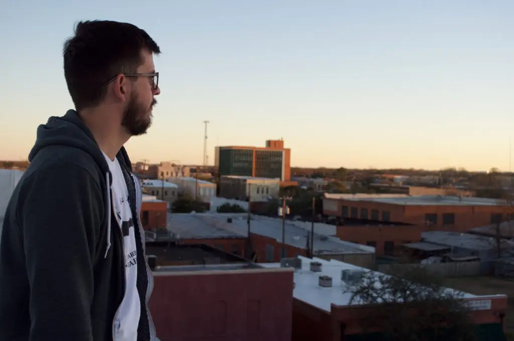 The author on the rooftop of 100 West gazes out upon the metropolis of downtown Corsicana. (Photo by Kyle Hobratschk)