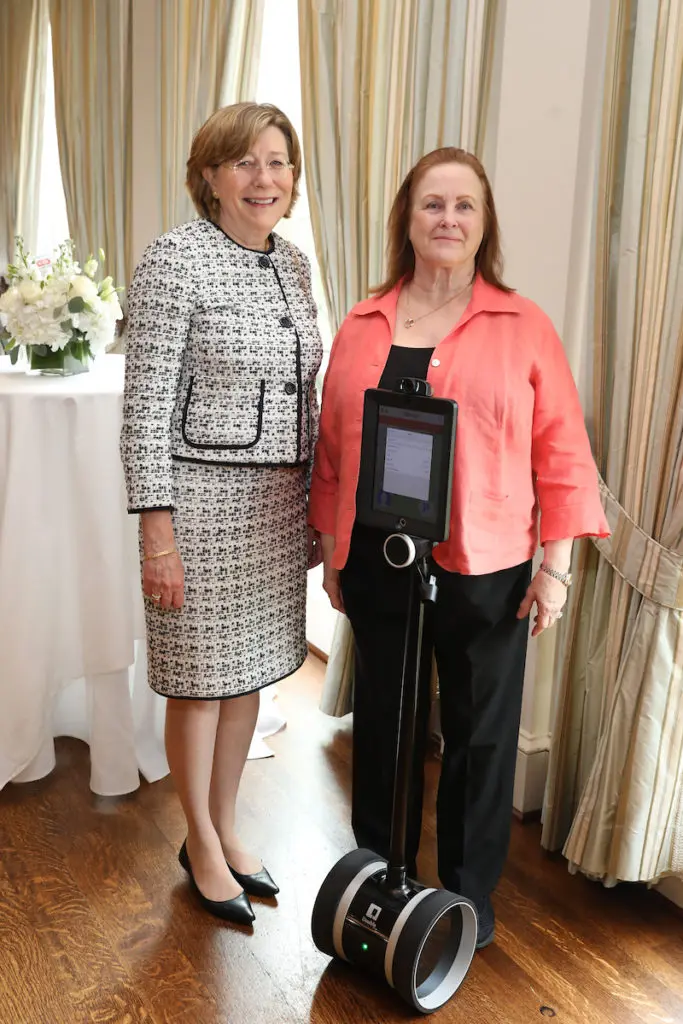 Constance Johnson and Gloria Hill check out the new Giraffe technology at the  PARTNERS luncheon benefiting the Cizik School of Nursing at UTHealth. (Photo by Priscilla Dickson)