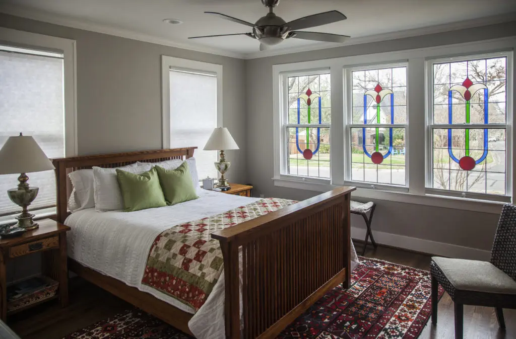 A classic cottage bedroom with stained-glass windows. (Photo by Kim Leeson)