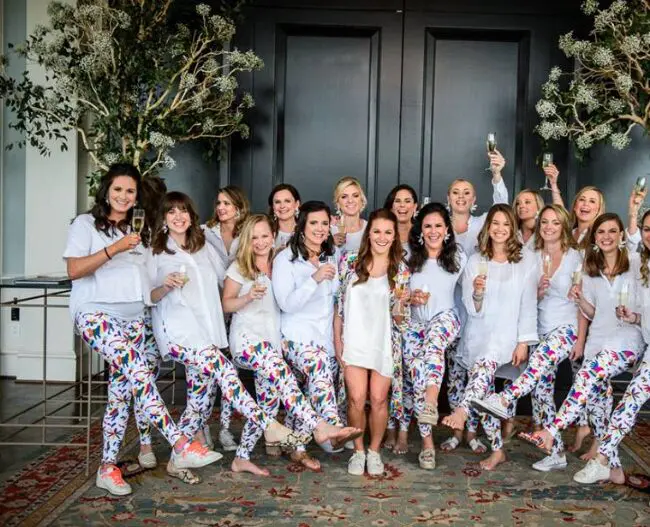 Some bridesmaids get ready in floral robes, but it was vibrant pants for these ladies.  (Photo by Chris Bailey )