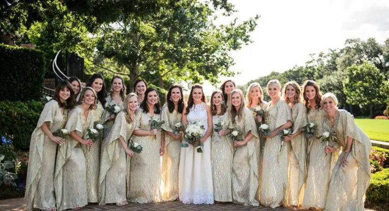 The bridesmaids looked glam in gold caftans.  (Photo by Chris Bailey )