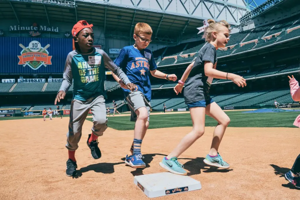 Christopher Yancy, Cason Paul, Claire Paul run the bases at Minute Maid Park during the Texas Children's Hospital Family Fun Day. (Photo by Chin Phan)