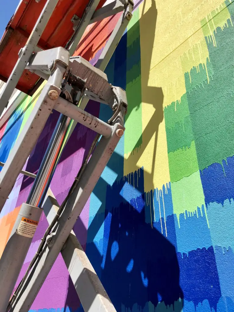 "Pearl Paint Wall" in process, showing the pixelated grids that form five portraits representing the construction trade in Houston. Houston-headquartered developer Morgan commissioned the public artwork for its new Pearl Marketplace at Midtown.  