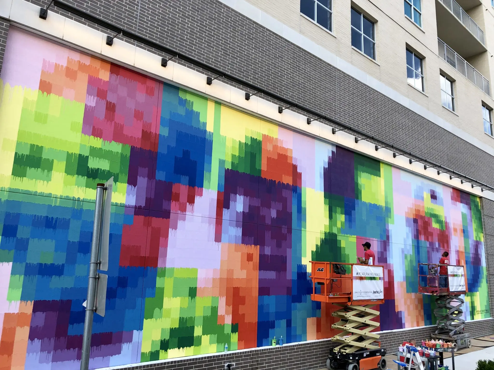 Five workers who represent the faces of Houston's diverse contracting industry appear in pixelated form on "Pearl Paint Wall."