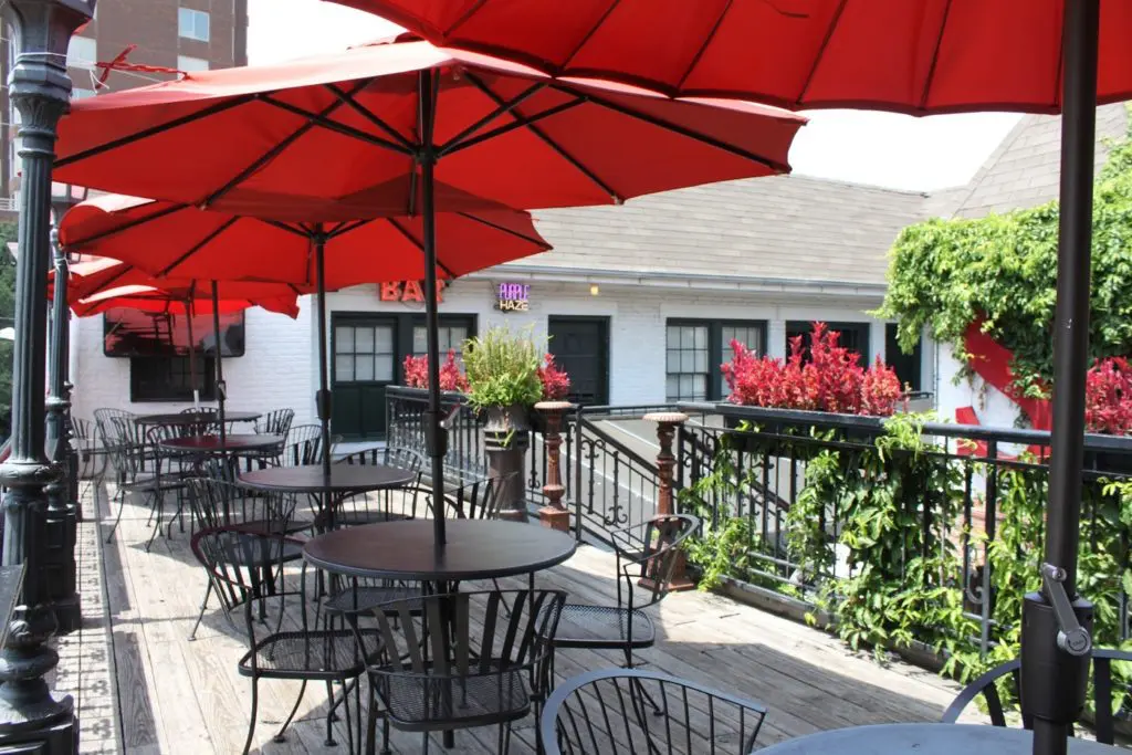 Quarter Bar has a second level with a rooftop bar, pool table, and dart board.