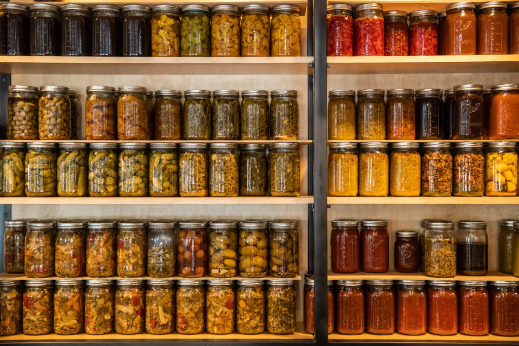 Preserving ingredients in various ways brings out different flavors, and makes for an eye-catching wall (Photo by Reed Kenney)