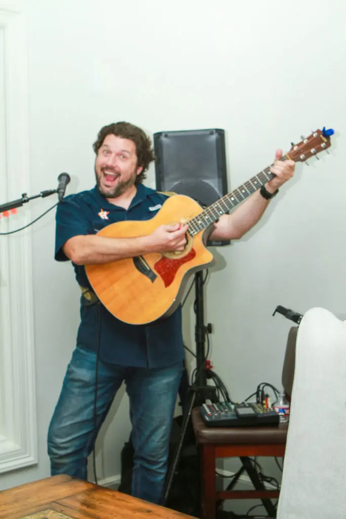 Guitarist Adam Estes performs at the John Daugherty open house in Memorial. (Photo by Chris Bachman)