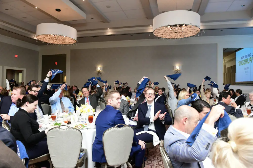Rally towels on high at the Center for Pursuit luncheon. (Photo by Daniel Ortiz)