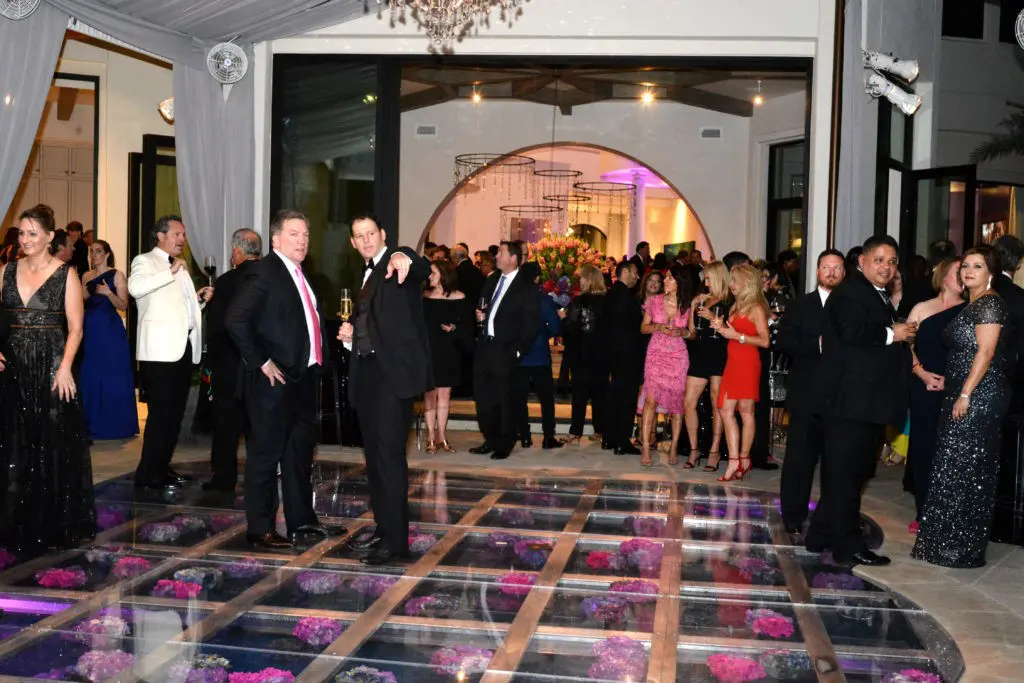 The see-through dance floor reveals fresh flowers floating just beneath the acrylic flooring at the Theorem Wine release party. (Photo by Al Torres Photography)