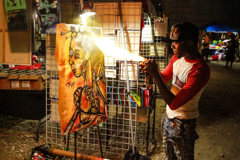 A fire-blowing moment at the Fifth Anniversary of Mr. D's "Préservons la Création" mural in Midtown. (Photo by Chris P. Bachman)
