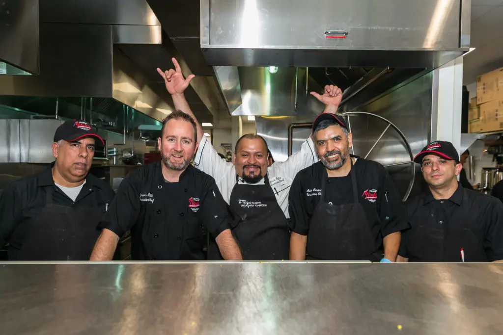With sous chefs on either end, Jason Gould, Alex Padilla and Adan Vasquez celebrate at the Original Ninfa's Uptown opening night. (Photo by Emily Jaschke)
