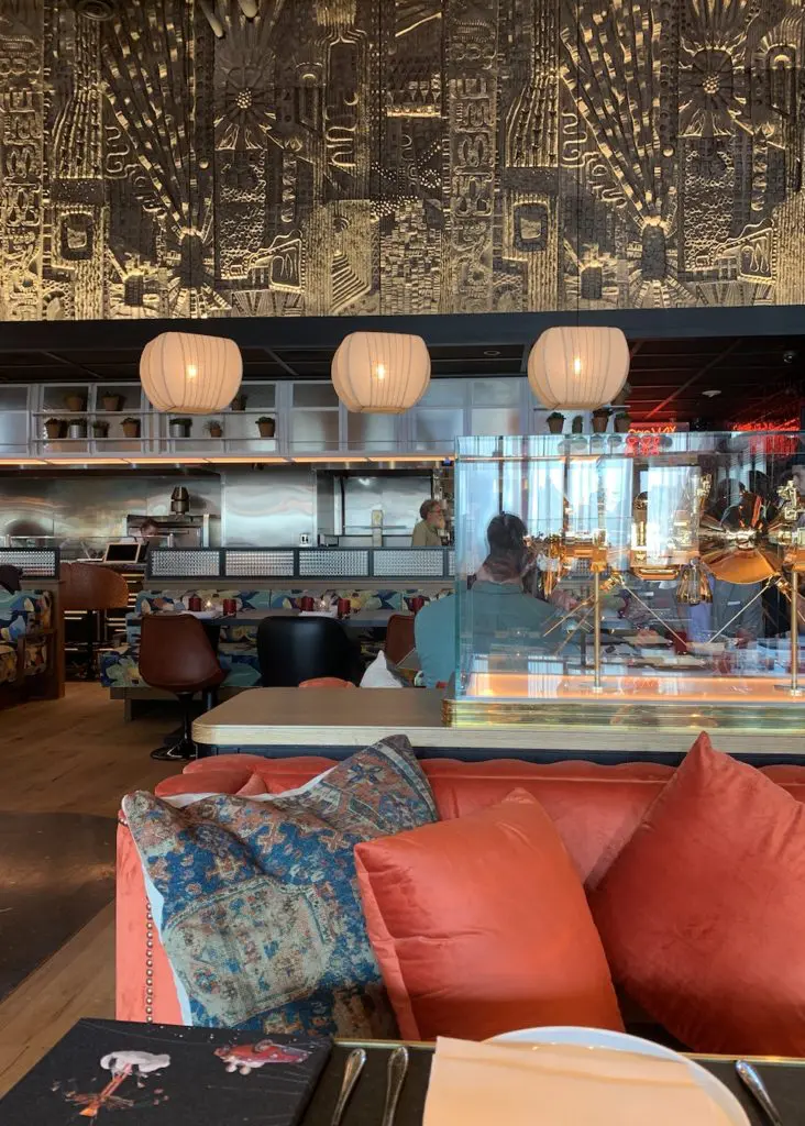 The relief mural above the open kitchen is stunning.  (Photo by Public Content)