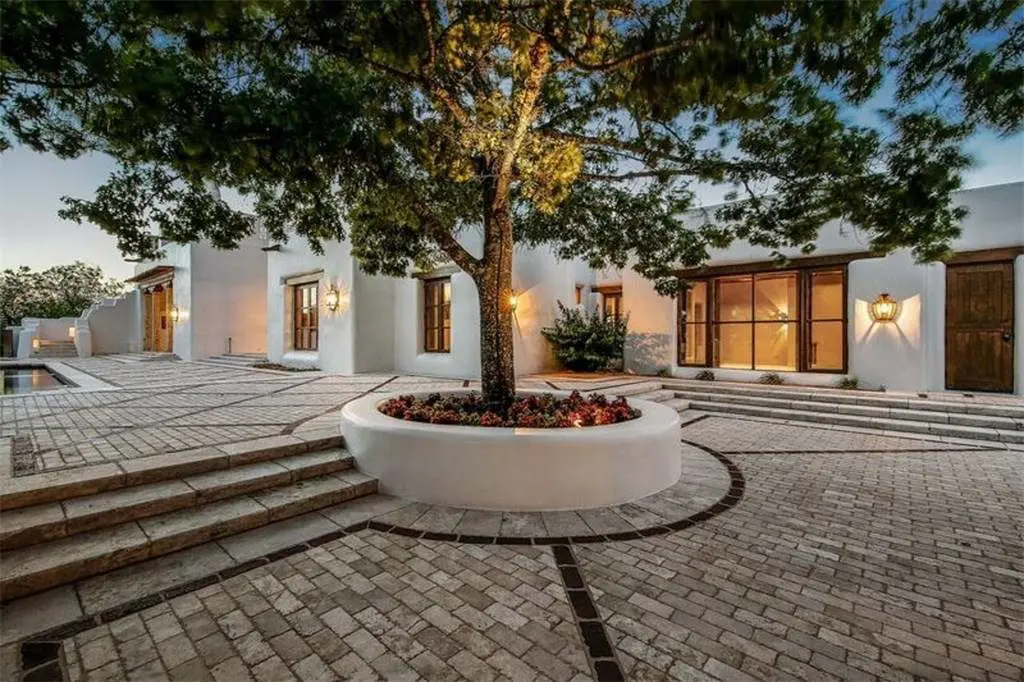 Trees add an organic element to the adobe home. 