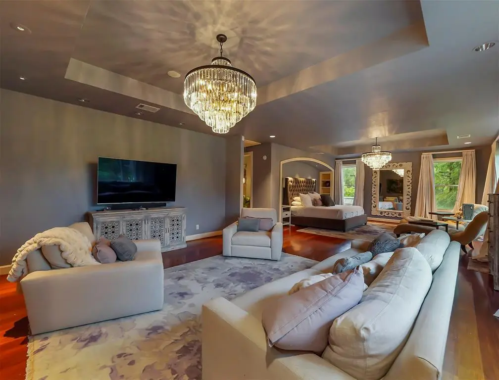 The chandelier gleams over a beautiful room. 