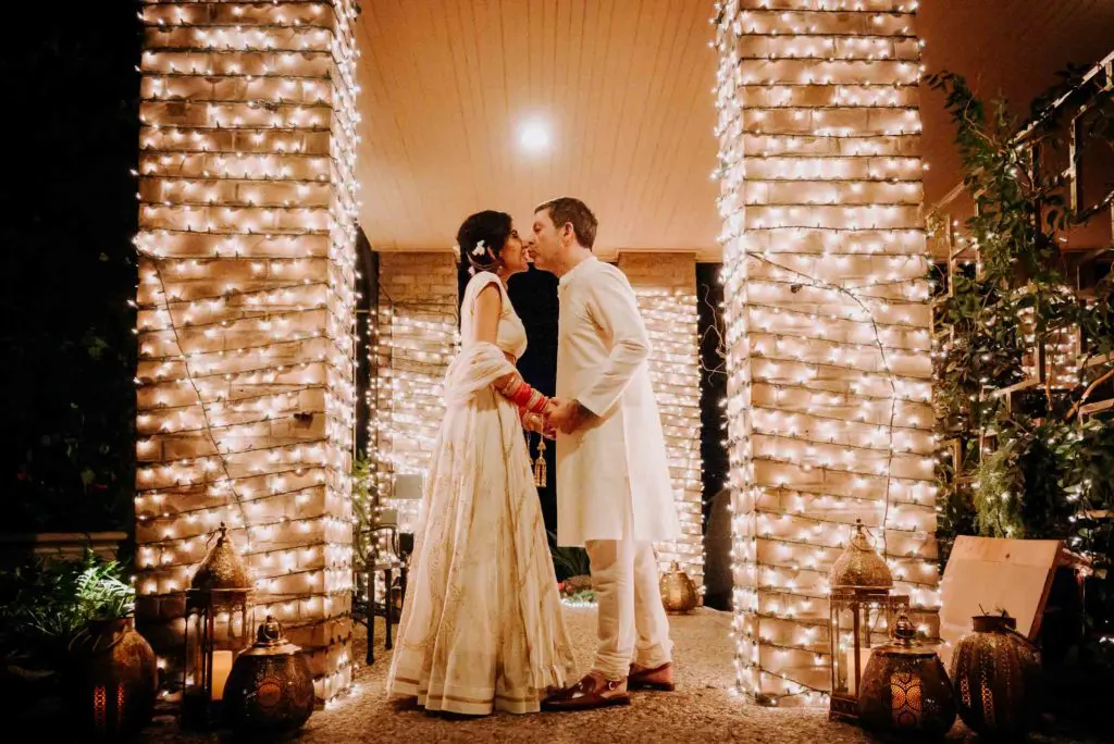 Gary Chapman and Puja Verma share a kiss after the haldi, held in the home of the bride's parents. (Photo by Philip Thomas)