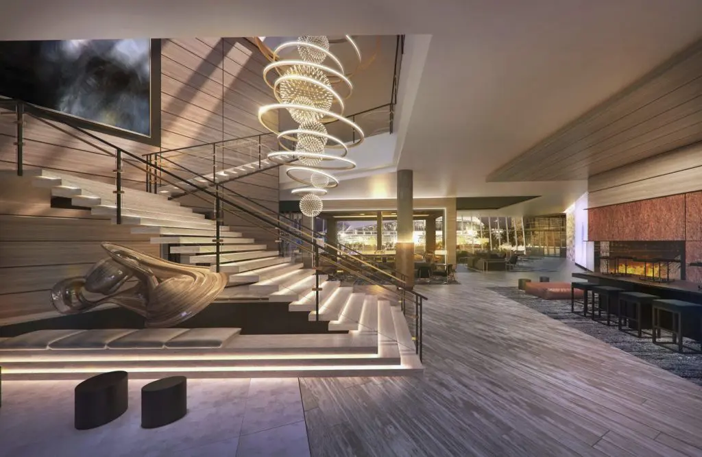 The lobby features an artsy chandelier and fireplace. 