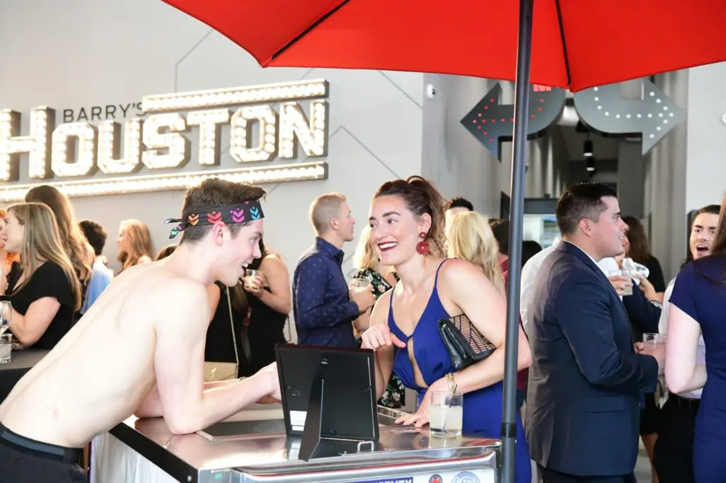 A topless model serves boozy popsicles at the Barry's celebratory opening in River Oaks Shopping Center (Photo by Daniel Ortiz)