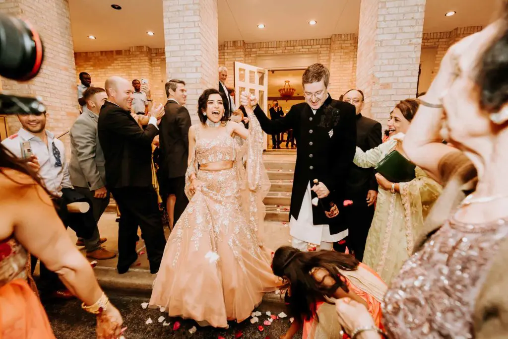 Mr. and Mrs. Gary Chapman depart River Oaks Country Club amid a shower of rose petals. (Photo by Philip Thomas)