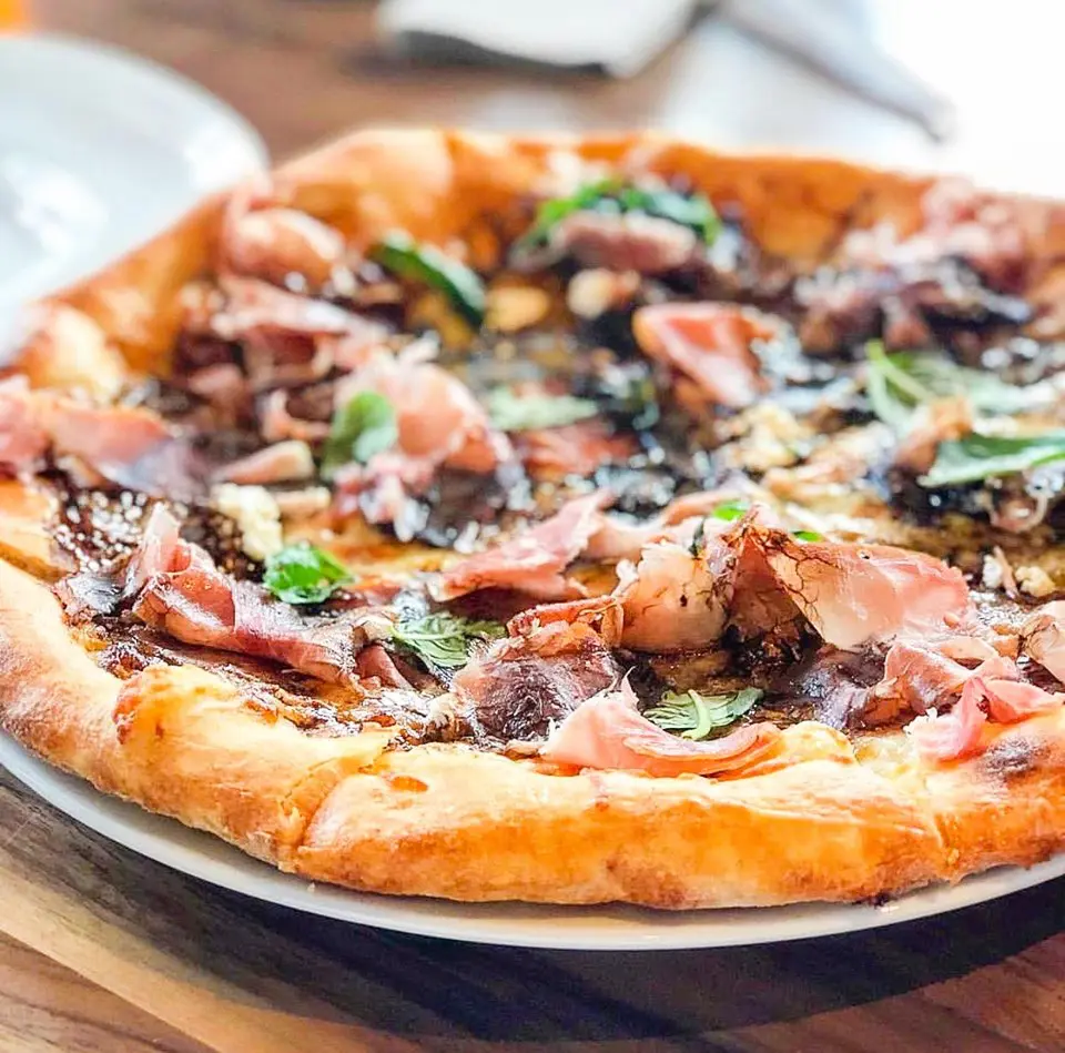 The Fig & Pig pizza at bellagreen features fig jam, prosciutto, three cheeses and a drizzle of balsamic vinegar. (Photo courtesy bellagreen)