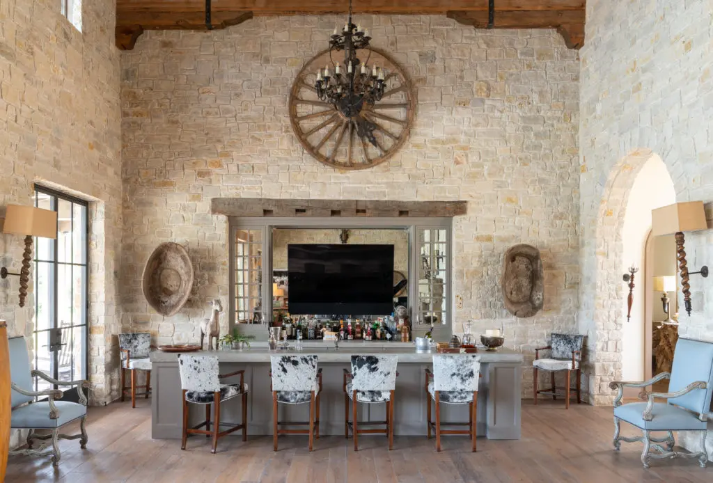 The bar area of the living room features hair-on-hide bar stools. (Photo by Michael Hunter)