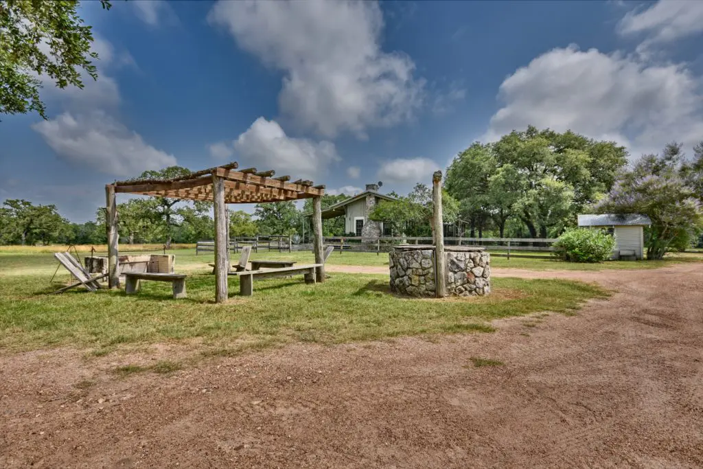 The sitting area with fire pit and water well lie a stone's throw from the main house. (Photo by John Deans, Deans Imaging)