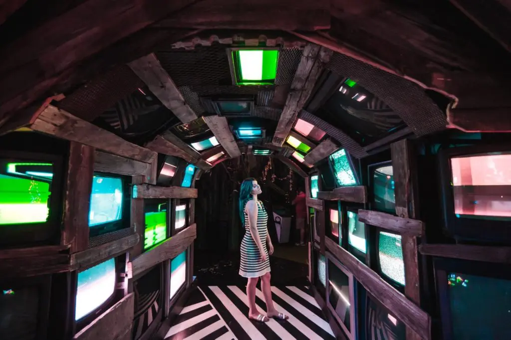 A visitor is transfixed on the video screens in Meow Wolf. (Photo by Kate Russell, Courtesy of Meow Wolf)