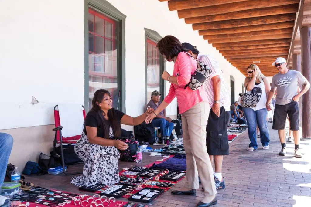 Shoppers peruse Indian crafts at the Santa Fe Governor's Palace. (Photo by TOURISM Santa Fe)