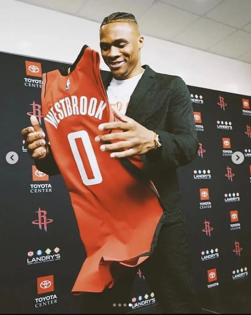 Russell Westbrook seemed to get a kick out of his new reds Houston Rockets jersey. (@russwest44)