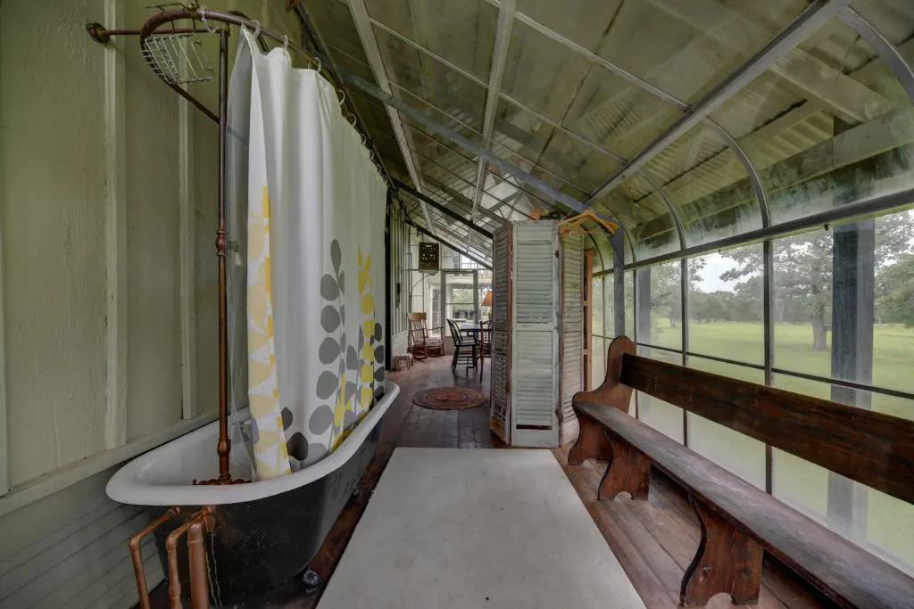 The sunroom in the main house offers a unique shower opportunity. (Photo by John Deans, Deans Imaging)