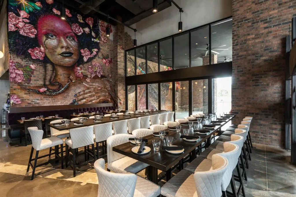 The modern bistro has a soft yet bold color palette and many metals. (Photography by Julie Soefer)