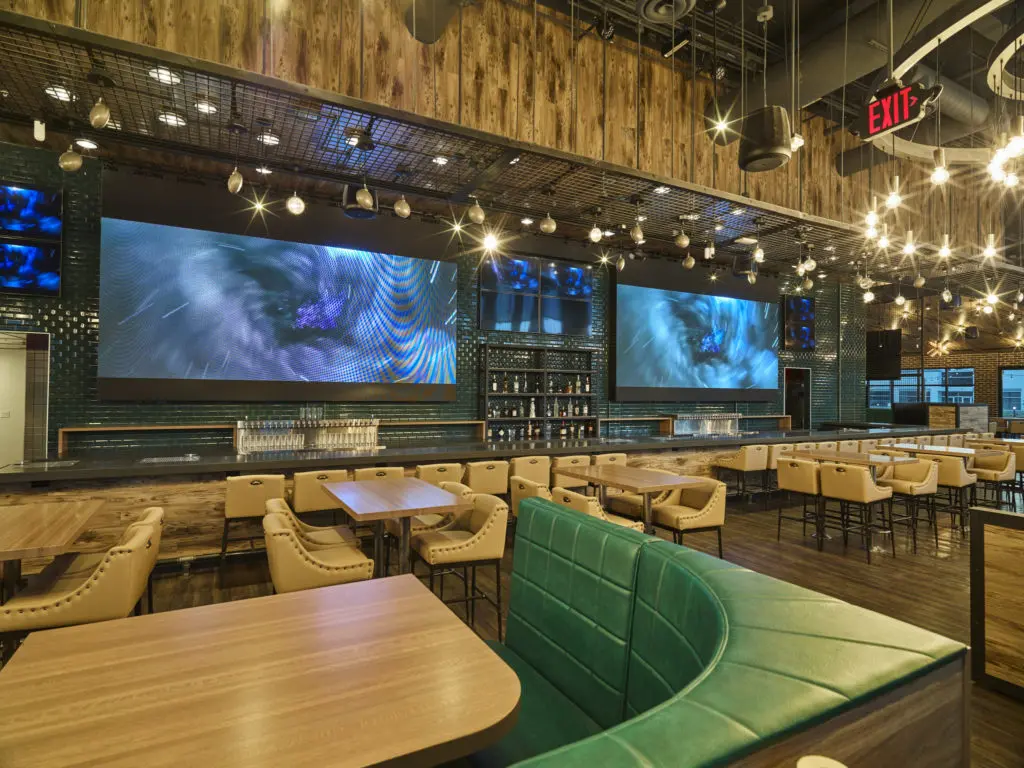 Shark Club's interior features Dallas Stars decor like Victory Green and giant TVs.