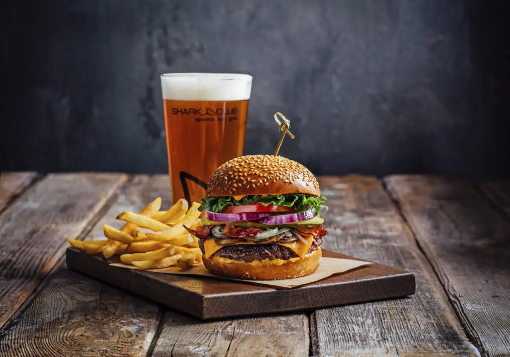The sports restaurant and bar serves burgers and beer.