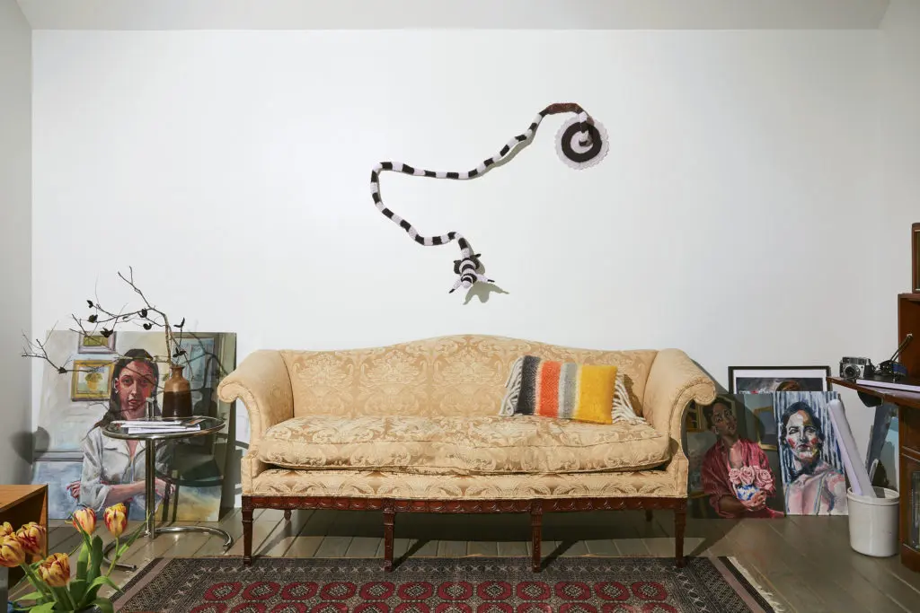 Works in progress by Havana-born de las Cuevas lean against the rear wall of the studio/sitting room. The brocade-covered camelback sofa belonged to Koush’s maternal grandmother. Taxidermy squirrel sporting a crochet bodysuit is by Houston artist Elaine Bradford. (Photo by Pär Bengtsson)