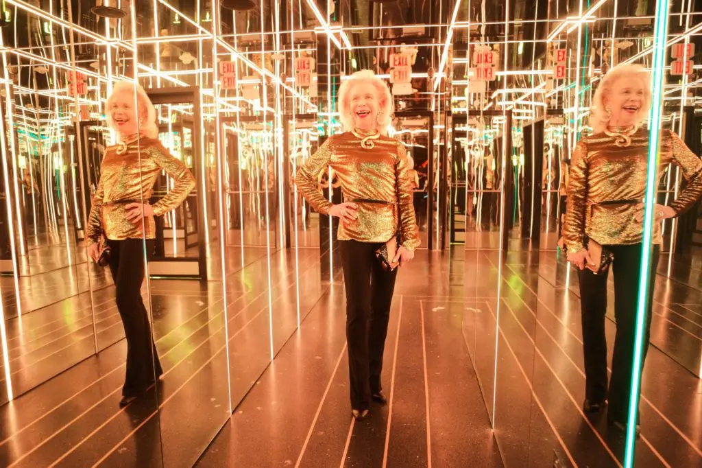 Rothko Chapel ambassador Lynn Wyatt enjoys a moment in the mirrored hall of MAD during a special benefit.  (Photo by Daniel Ortiz)