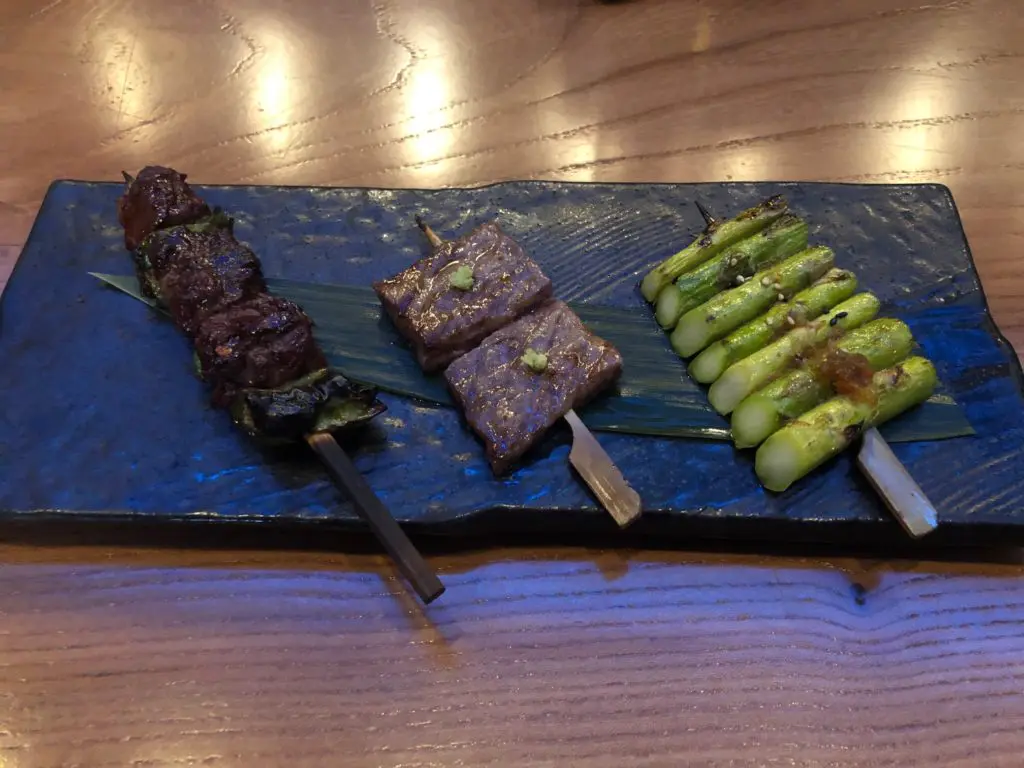 The final course of the Roka Reserve features the Domestic Wagyu Filet Skewer, from left, the tantalizing Japanese Waguy Skewer, and the Asparagus Skewer.