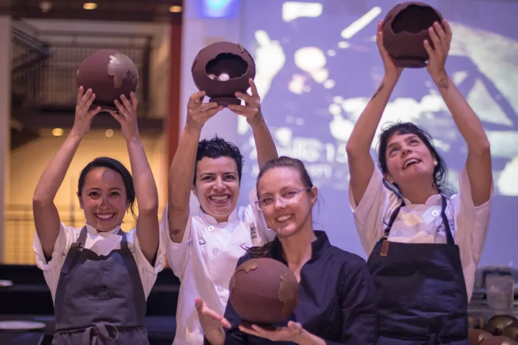Karla Espinosa, Debora Teixeira, Leanne Akers, Manu Bufarra lifting the volley ball-sized dessert globes,. (Jack Potts photo)
