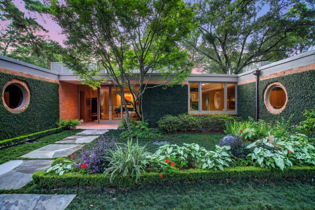 The mid-century masterpiece by Hugo Victor Neuhaus Jr., tucked on Lazy Lane in the heart of River Oaks, is privately on the market for more than $11 million. The sale is being handled by John Daugherty Realtors. (Photo by TK Images)