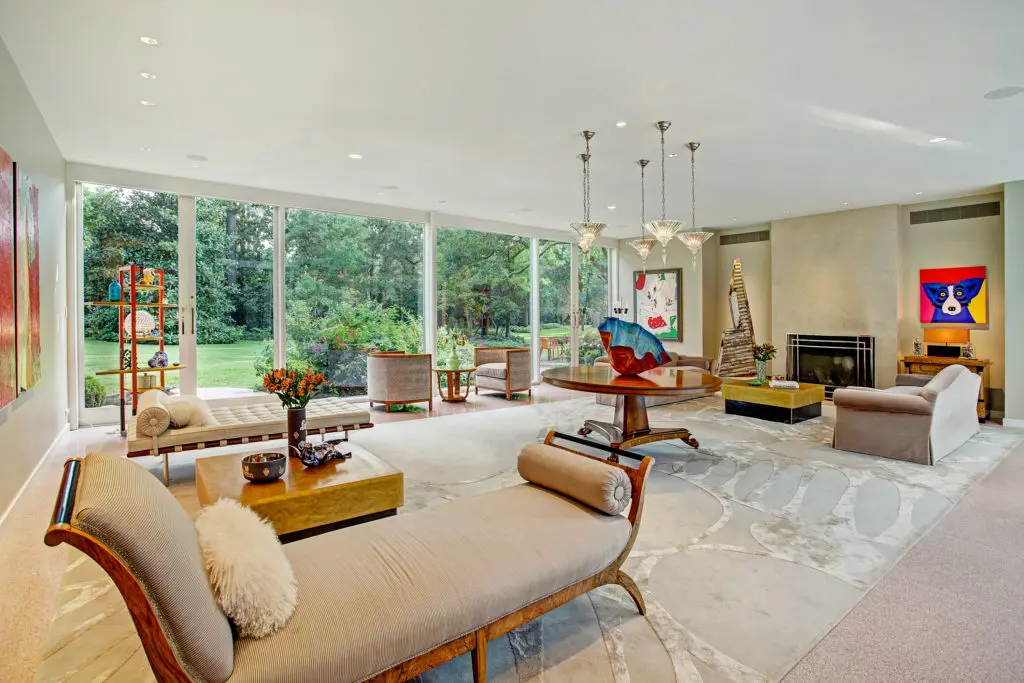 The living room offers unobstructed views into the lush gardens.  (Photo by TK Images)