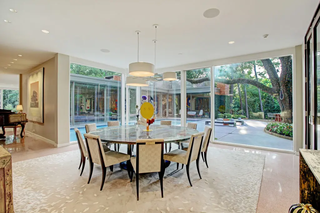 The formal dining room overlooks the swimming pool and the gardens beyond. (Photo by TK Images)