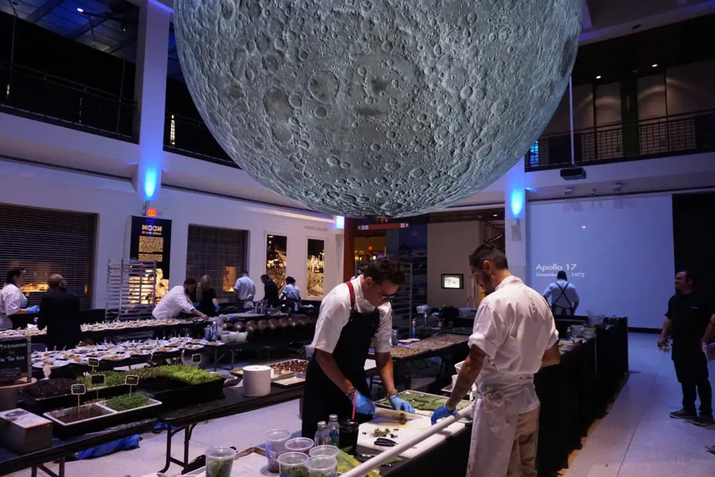 Behind-the-scenes prep for the Around the World in 10,000 Bites, beneath a massive moon at the Houston Museum of Natural Science. (Mai Pham photo)