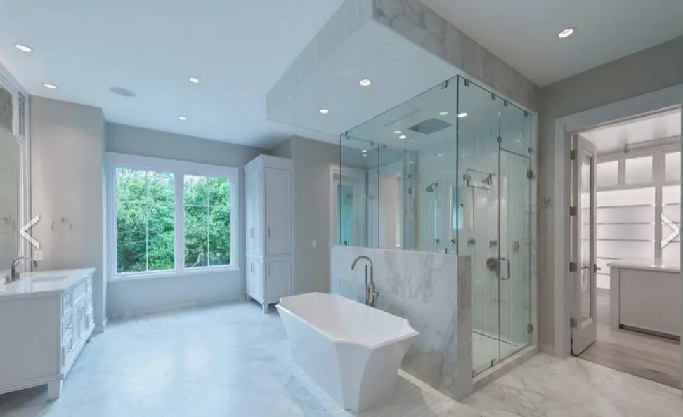 This master bath in a River Oaks home features furniture grade vanities and built-in cabinets, a large steam shower, dual water closets with bidets.
