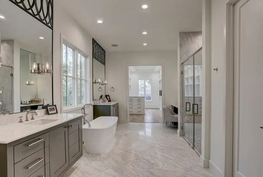 Designed for both form and function the master bath boasts  three vanities, two with Brizo Litze 8” faucets in polished nickel and Caesarstone counters. 