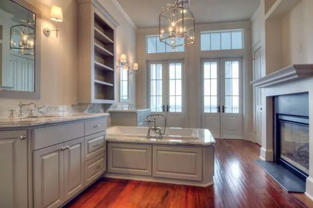 Architect Steve Mouzon designed the Galveston Beachtown home with a master bath complete with hardwood floors, a gas fireplace and doors opening to a gallery overlooking the Gulf.