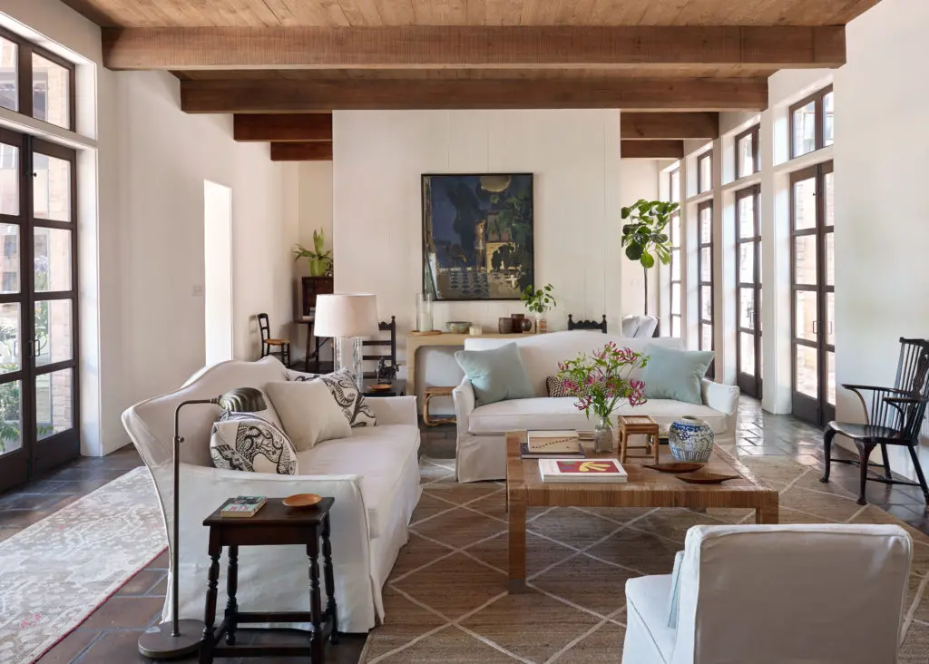The living room of an exuberant Houston home designed in 1977 by architect I. W. Colburn. Interior design Tom Scheerer. Sangram Majumdar painting, vintage Bielecky coffee table. Saltillo tile floors are original to the home.  (Photo by Francesco Lagnese)