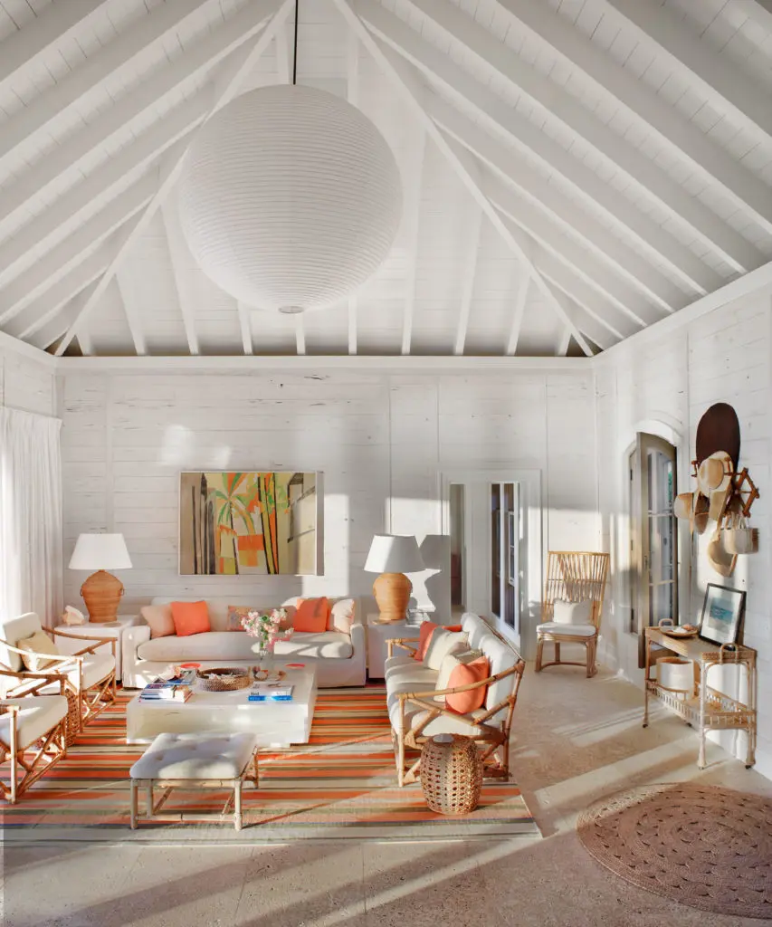 On a family compound on a barrier reef, the living area is paneled in whitewashed pecky cypress. Encaustic painting over sofa was  found in a Palm Beach shop.  (Photo by Francesco Lagnese)