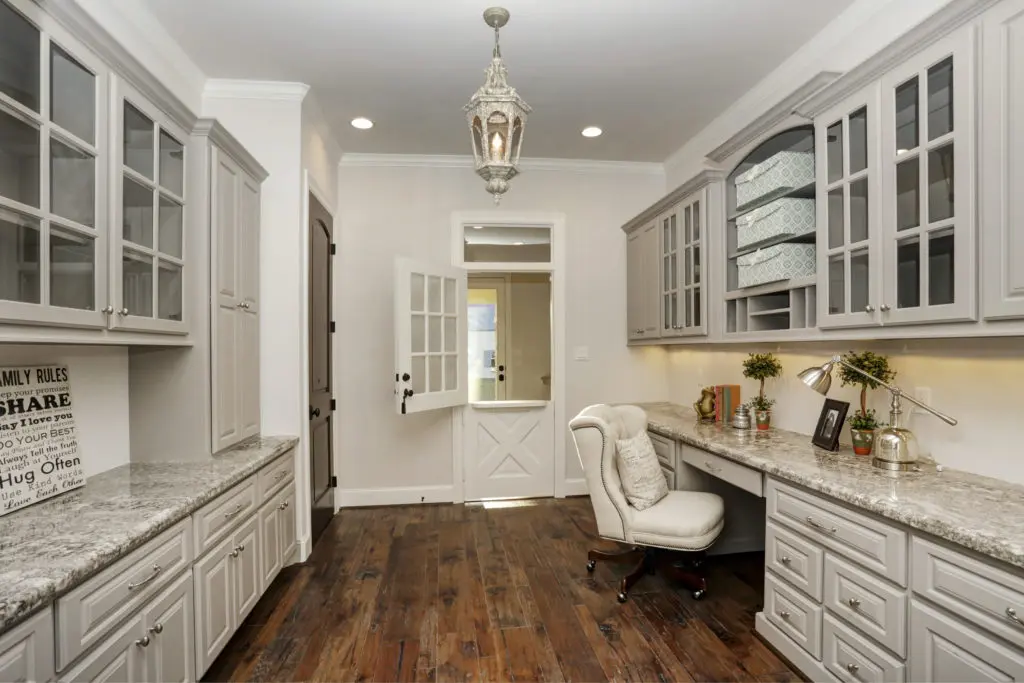 A familiar take on the all-so-necessary home office with ample storage and built-ins, this design is often located next to the kitchen. 