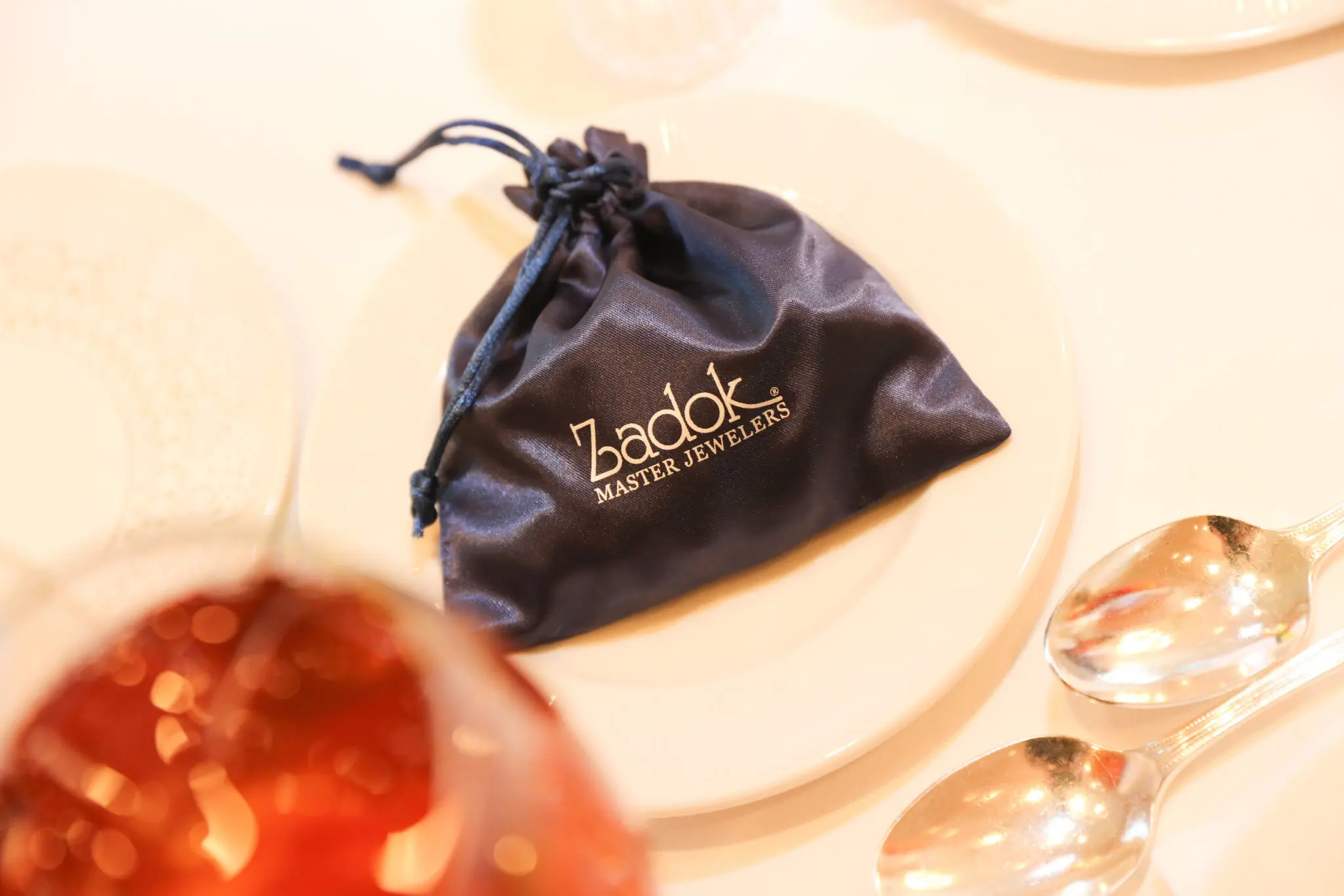 Zadok Jewelers gifts every luncheon guests with a fabulous string of pearls in a silk pouch. (Photo by Priscilla Dickson)