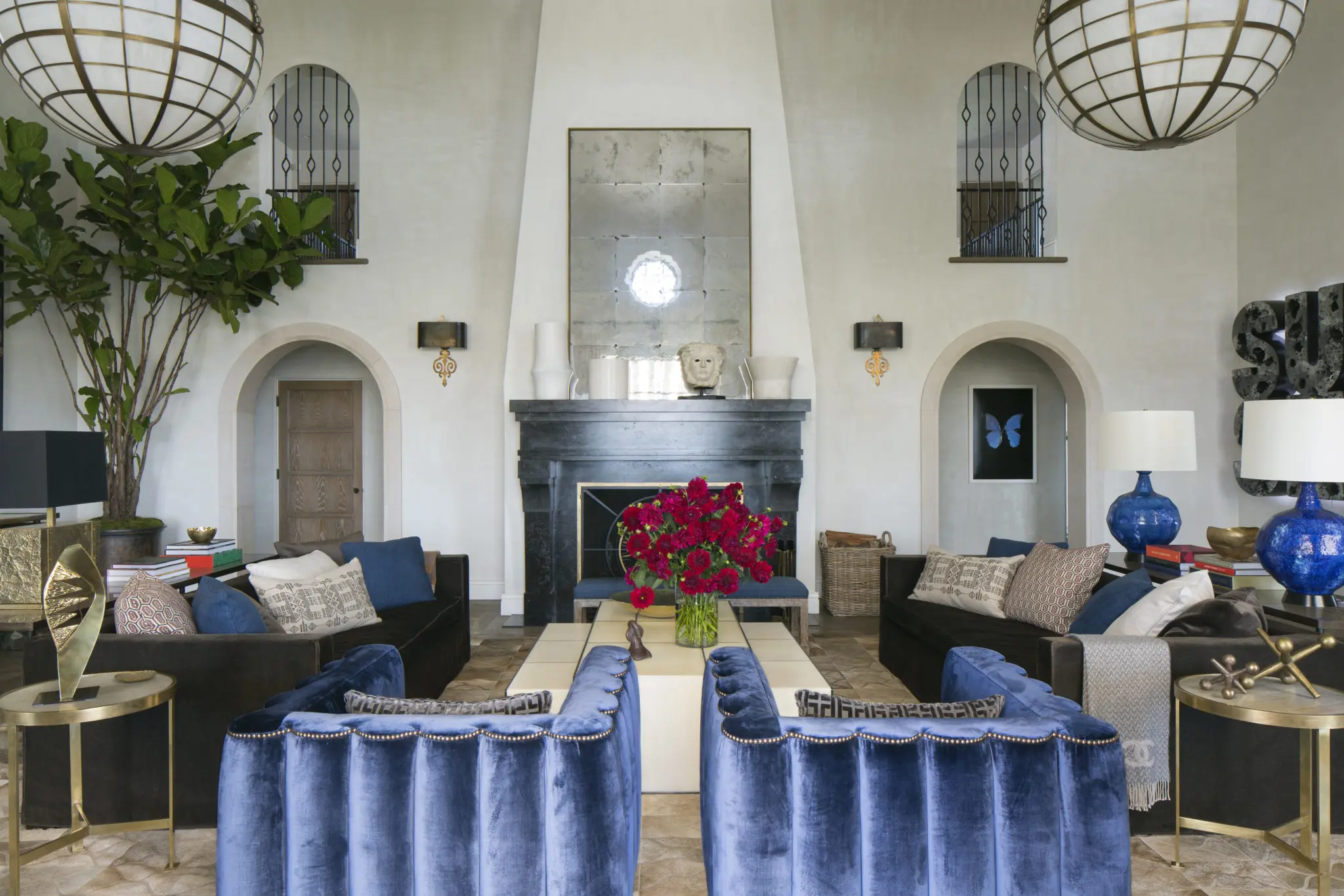 In Ellen Pompeo's Hollywood home, the Prussian blue silk velvet-covered wave chairs add a 1940s club atmosphere to the living room. The original fireplace was badly damaged, so Bullard created a new one in bold basalt, based on a seventeenth-century Tuscan design.