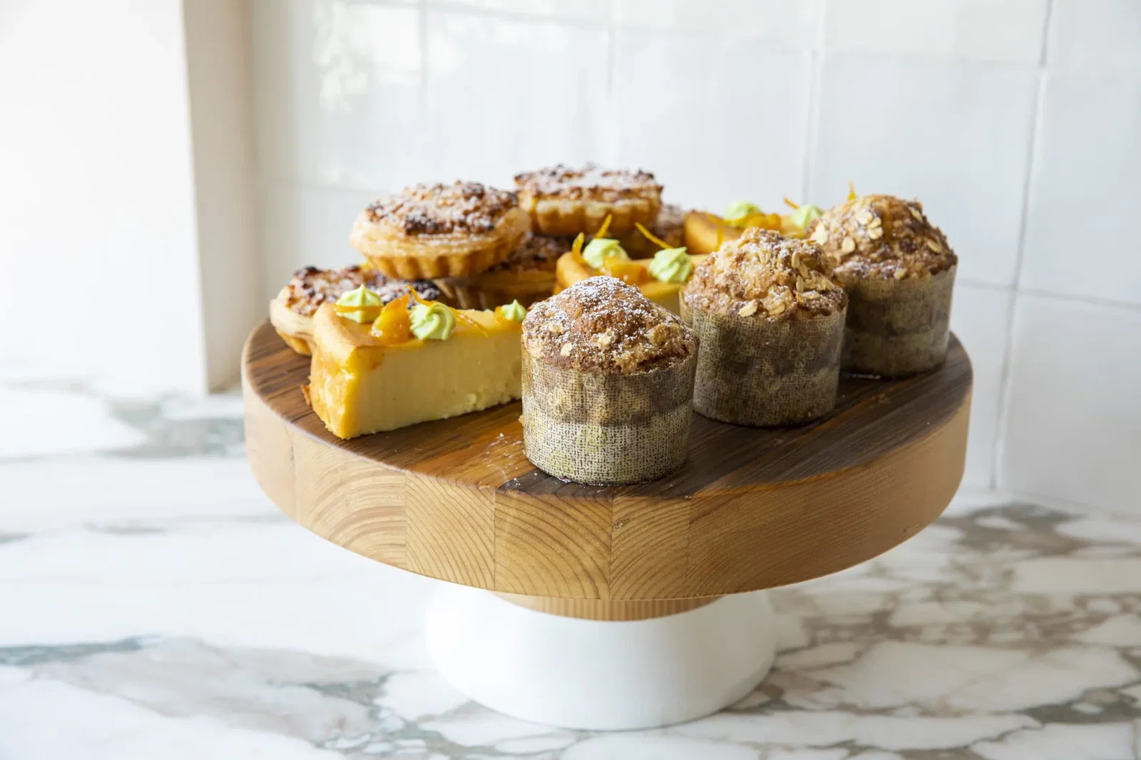 Back to front: Migliaccio (ricotta and semolina cake); Pastel De Nata (Portuguese egg tart); Pantxineta (Basque almond tart); Oat streusel muffin (Photo by Julie Soefer)